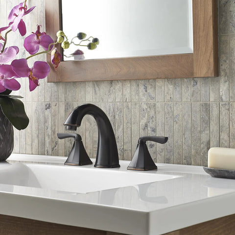 Selia 8 Inch Widespread Bathroom Sink Faucet Two Handle 3 Hole Deck Mount In Tuscan Bronze Finish next to a flower vase