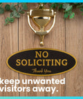 No Soliciting Sign For Home Or Business, Durable Indoor Outdoor Front Door Sign With Easy Mount Adhesive, UV And Weather Resistant Black Sign With Gold Letters, Small 2 By 5 Inches on wood door with knocker.