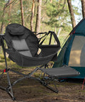 Hammock Camping Chair With Detachable Footrest And Cup Holder beside a tent in a forest setting, highlighting portability and comfort.