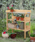 Potting Bench With Natural Wood Top And 3 Tier Shelves Outdoor Garden Workstation With Hooks Fir Wood Potting Table shown in garden