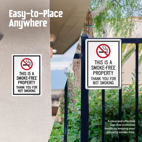 Straight Up Smoke Free Property Sign Featuring Bold No Smoking Symbol, 14 X 10 Inch Heavy Duty Rustproof Aluminum Metal Wall Yard Sign, Super Durable Indoor Outdoor Setup, Made Right In Usa displayed on a wall and fence.