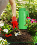 Gardener using Handheld Lawn Seed Spreader With Adjustable Hole Size Dial Lid, 2 Liter Capacity for planting among flowers