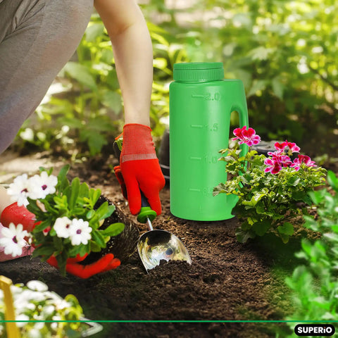 Gardener using Handheld Lawn Seed Spreader With Adjustable Hole Size Dial Lid, 2 Liter Capacity for planting among flowers