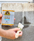 Applying Waterproof Patch And Seal Liquid Black 16 Oz Seals Out Water Air And Moisture With Flexible Rubberized Coating to wall