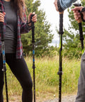 Hikers using Lightweight Carbon Fiber Trekking Poles Set Of 2 With Quick Adjustable Locks For Hiking And Walking Blue outdoors.