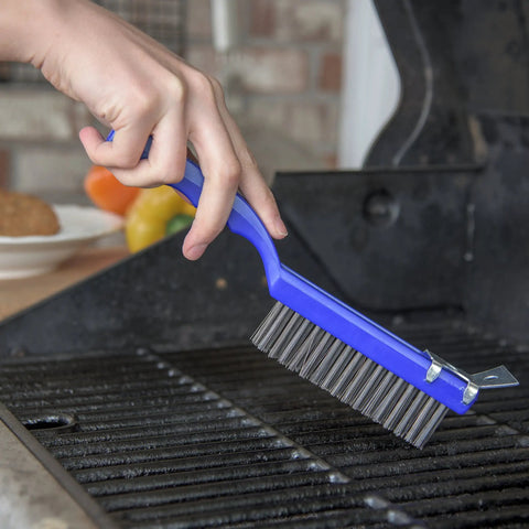 Flo Pac Plastic Grill And Kitchen Cleaning Brush With Scraper 11.38 Inch Griddle Brush For Home And Restaurant in use on grill