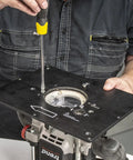 Hands adjusting the Heavy Duty Portable Benchtop Router Table Featuring A Rock Solid Steel Frame 24 By 16 Inch Laminated Work Surface.