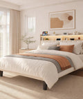 Queen Size Upholstered Bed Frame With Built In Charging Headboard And Hidden Storage Shelves Beige Platform Base in bright bedroom.