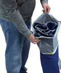 Person packing Pod Rocker Outdoor Rocking Chair With SunShade Canopy into its carry bag, showing compact foldability.