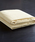 Folded beige Non Slip Rug Pad Grippy Anti Skid Grip For Under Rugs And Carpets Stay In Place On All Hard Floors 6 Foot Square Open Weave