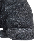 Close-up of Solar Black Labrador Dog Garden Statue With LED Bone Welcome Sign in realistic resin detail