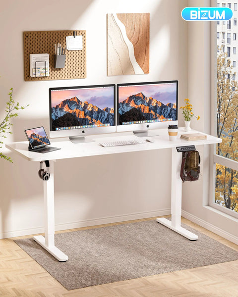 Sleek BIZUM Electric Standing Desk 60 x 24 Inch White Computer Gaming Workstation with dual monitors and notebook.