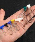 Hand holding Heavy Duty Sinker Slides For Catfishing Rig Tackle 70 Piece Set With Stainless Steel Duo Lock Snap Swivels