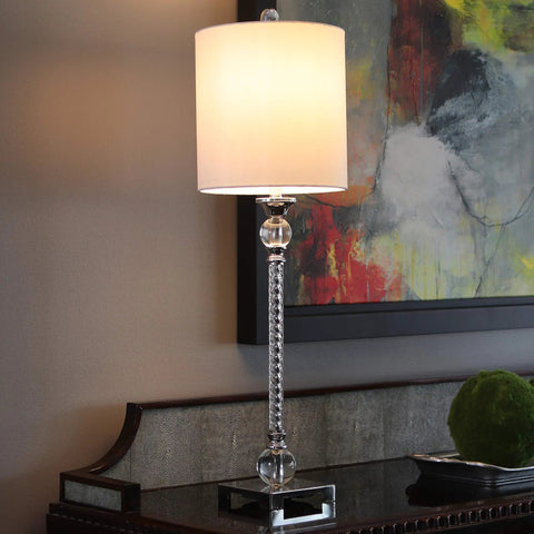 Camilla Steel And Acrylic Twist Buffet Lamp In Chrome And Clear Finish With Silver Faux Silk Shade on a sideboard in living space.