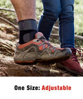 Person wearing Deluxe Ankle Stabilizer With Adjustable Support In Black 1 Pack on trail, customizable compression visible