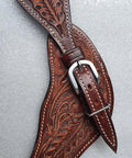 Oakleaf Tooled Leather Spur Straps For Adults with hardware and buckle, brown horse tack against a gray background
