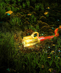 Beefy Outdoor Extension Cord 200 Feet Waterproof 12 Gauge 3 Conductor with Lighted End glowing in grassy terrain