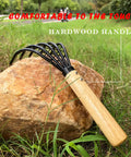 Five Claw Garden Rake Dethatching Tool For Loosening Soil Weeding Leaf Removal Beach Treasure Digging And Shell Cleanup Durable Garden Tool Built To Hack Through Tough Dirt with hardwood handle on rock