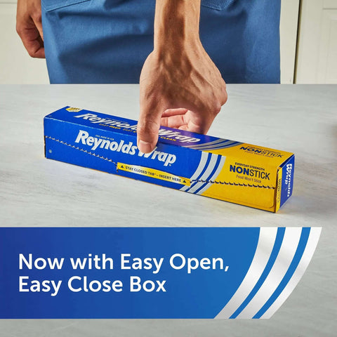 Person placing a hand on blue box of Nonstick Aluminum Foil Roll For Easy Cooking And Mess Free Cleanup Perfect For Covering Casseroles