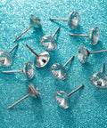 Several 100 Piece Crystal Upholstery Nails And Tacks Set For Furniture Sofas Headboards And Cork Boards on blue surface