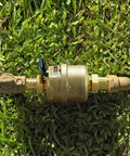 Three Quarter Inch Non Pulsed Rotary Piston Water Meter with heavy-duty brass construction on grass