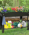 Big Outdoor Raised Garden Bed With Legs And Wheels Metal Planter Box For Vegetables Flowers And Herbs Elevates Your Patio Or Backyard Grow Space Forty Inch Long By Eleven Inch Wide By Thirty One And A Half Inch High filled with colorful flowers, gardening tools below.