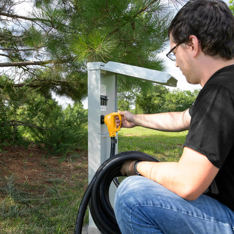 Person using Power Grip 30-Foot 50-Amp Camper RV Extension Cord With Copper 6/3 And 8/1 Gauge Wires outdoors at power station