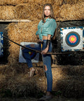 Archer posing with recurve bow in front of Bulk 30 Pack Archery Target Paper 40x40cm 10 Ring Indoor Target Faces on hay bales