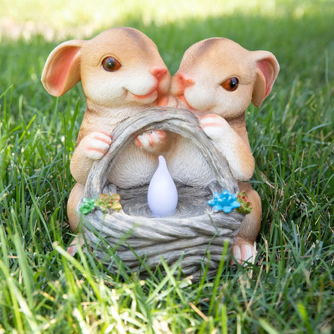Solar Powered LED Outdoor Bunny Garden Light Statue For Yard And Lawn Decor with glowing basket feature on grass.
