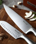 Close-up of two German Stainless Steel Kitchen Knives on a wooden board, showcasing the sharp blades and stainless steel handles.