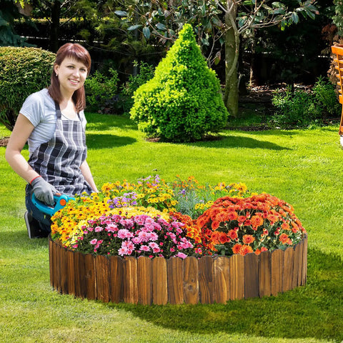 Woman gardening next to a weather resistant pine garden edging border fence for outdoor patio lawns and flower beds 11.8 feet by 8 inches