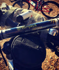 Waterproof Rechargeable LED Flashlight And Power Bank For Camping And Outdoor Adventures mounted on a bicycle handlebar.