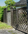 Spring Loaded Gate Wheel With 360 Degree Universal Mount installed on wooden fence gate outdoors