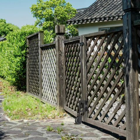 Spring Loaded Gate Wheel With 360 Degree Universal Mount installed on wooden fence gate outdoors