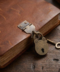 Vintage bear-shaped iron hasp lock on leather box, part of Two Pack Bear Shaped Iron Hasp Latch Lock Set For Tool Boxes And Small Chests