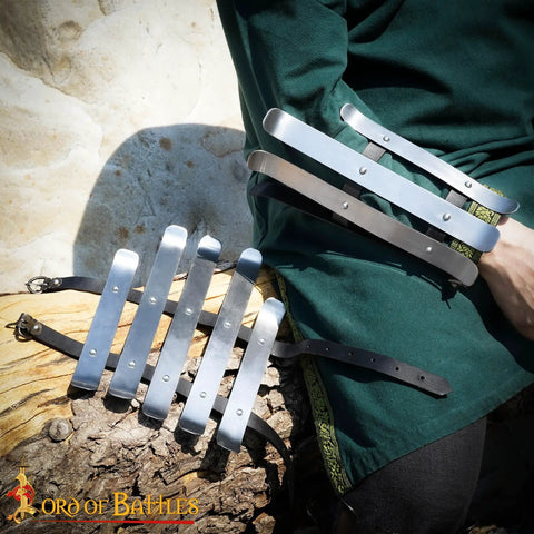 Person wearing medieval bracers for cosplay and reenactments, fully functional arm guards with splinted steel, Viking inspired armor.