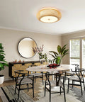 Dining room with Handwoven Bamboo Drum Flush Mount Ceiling Light With Rattan Shade 3 Light Boho Fixture illuminating table.