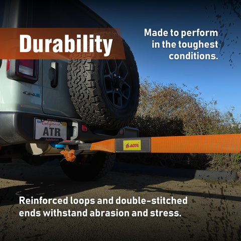 Heavy Duty Tree Saver Strap Three Point Five Inch By 8 Foot With 36000 Lbs Break Strength Beefed Up Polyester Webbing Tow Strap For Winch And Off Road Recovery Looped Ends For Truck And Jeep attached to a vehicle bumper.