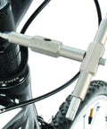 Mountain Bike Tool Kit With Replaceable Sticks And Bracket in use on a bike, showing close-up of tool engagement.