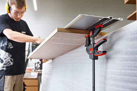 EZR Set Dope One Hand Table And Track Clamp with Quick Release used in woodworking, clamping wood to table, ergonomic design visible.