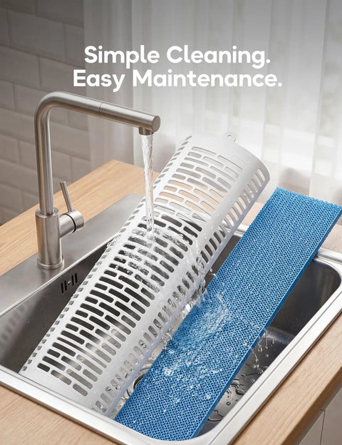 Washing a detachable evaporative cooler filter in a sink under a running faucet for easy maintenance.