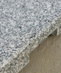 Close-up of natural grey granite surface on Mojave Outdoor Granite And Stainless Steel Umbrella Base Built To Last Heavy Duty 60 Pound Stand