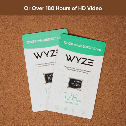 Two Wyze 128GB MicroSDXC Card Class 10 U3 for security cameras and dash cams, packaging on cork board.
