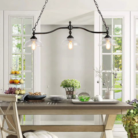 Farmhouse Chandelier Hanging Light Fixture in Rustic Black Metal with Three Bowl Shaped Clear Glass Shades over Dining Room Table