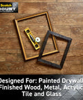 Four 1 Inch Permanent Mounting Squares on wood surface with frames and level, designed for painted drywall, metal, tile, and more.
