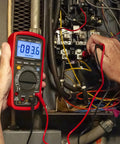 Person using True RMS 6000 Count Digital Multimeter With Low Pass Filter And NCV Detector in electrical panel