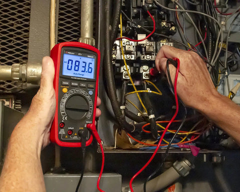 Person using True RMS 6000 Count Digital Multimeter With Low Pass Filter And NCV Detector in electrical panel