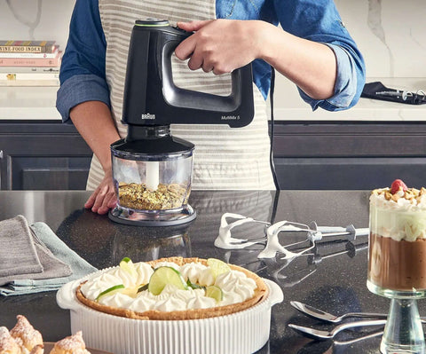 High Octane 350 Watt Hand Mixer With SmartMix Technology Nine Speed Settings And Turbo Mode in use, blending ingredients on kitchen countertop.