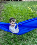 Child enjoying Kid Friendly Camping Hammock For Indoors And Outdoors, Ultra Comfy Hangout Hammock For Kids in a garden