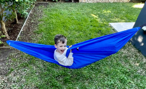 Child enjoying Kid Friendly Camping Hammock For Indoors And Outdoors, Ultra Comfy Hangout Hammock For Kids in a garden